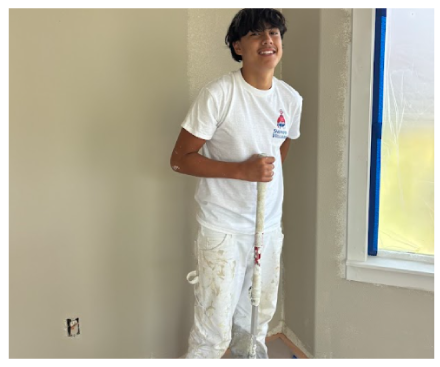 painting-professionals Painter carefully applying paint to a detailed section of a wall.